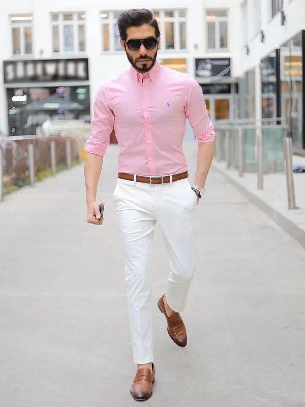 Premium AI Image | a woman in a pink shirt and black pants standing against  a pink wall